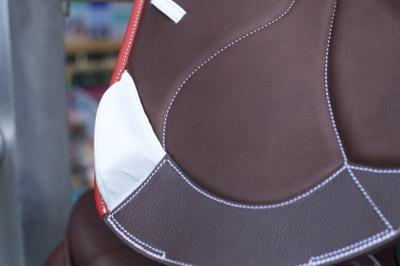 jump saddle with red piping and white accent